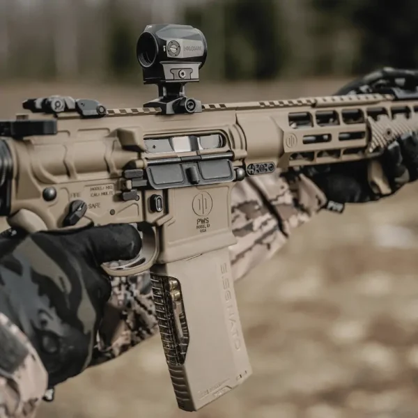 Shooter at range using Hera Arms H3MAG-T Flat Dark Earth 30-round AR-15 magazine with transparent, textured spine, compatible with 5.56, .223, and 300 Blackout
