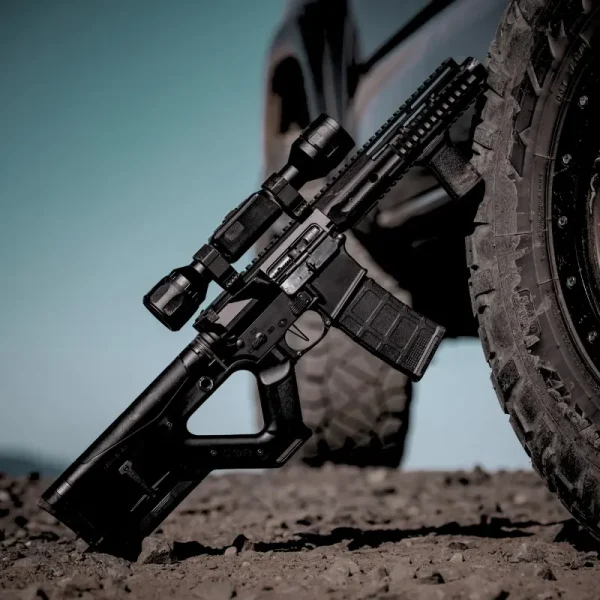 Close-up of Hera Arms CQR Gen 1.0 fixed AR-15 stock leaned against a truck for rugged field use